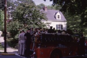 Group of neighborhood kids riding in the firetruck in Riverview Manor after the Memorial Day Parade 1966