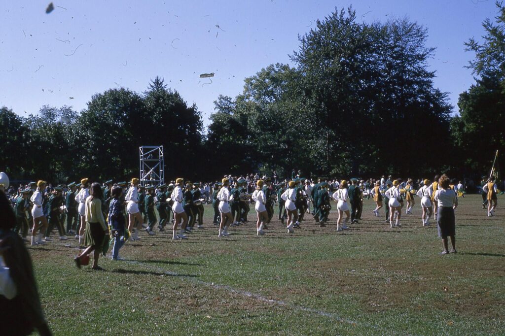 HHS Marching Band, Hudsonettes, and Twirlers taking the field at Gould Park in Dobbs Ferry in 1964.