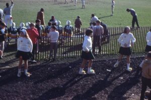 Cheerleaders on the sidelines at Reynolds Field during a Hastings Rams football game in 1967