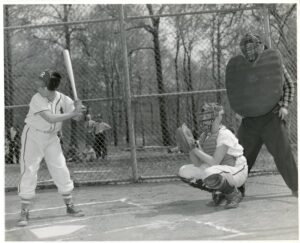 A batter, catcher, and umpire in what appears to be a Pony League game in the 1950’s.