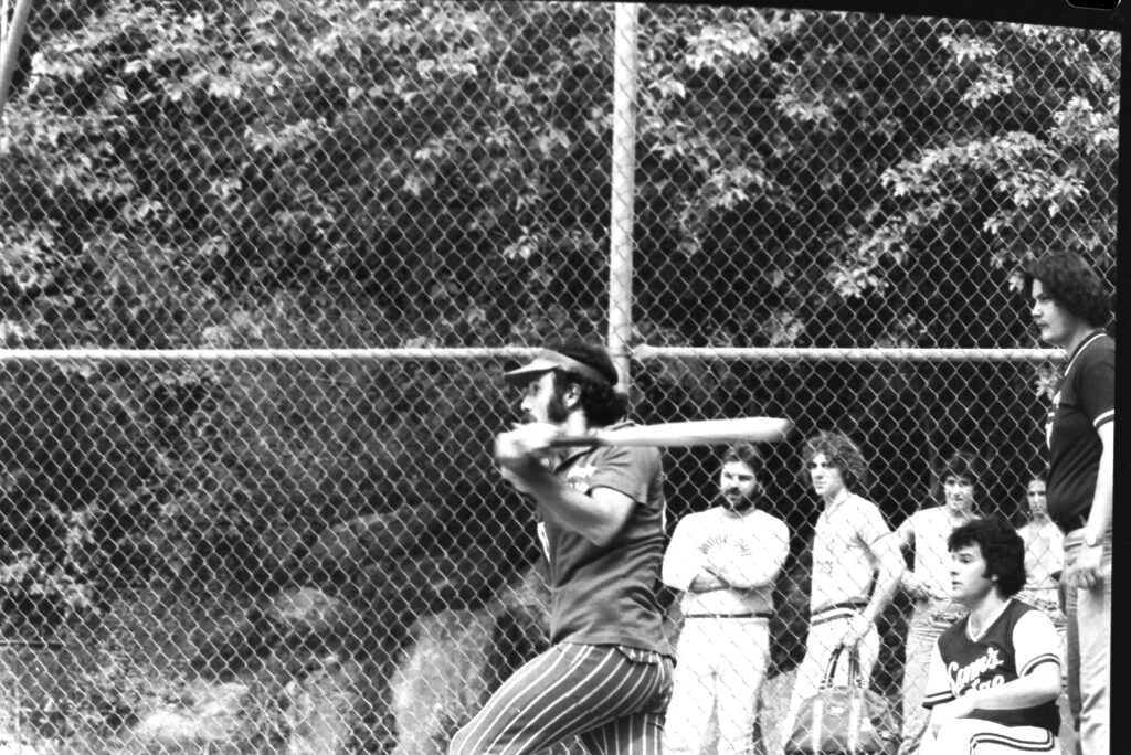 Patsy Cammisa up at bat at an adult softball game .  Circa 1980.