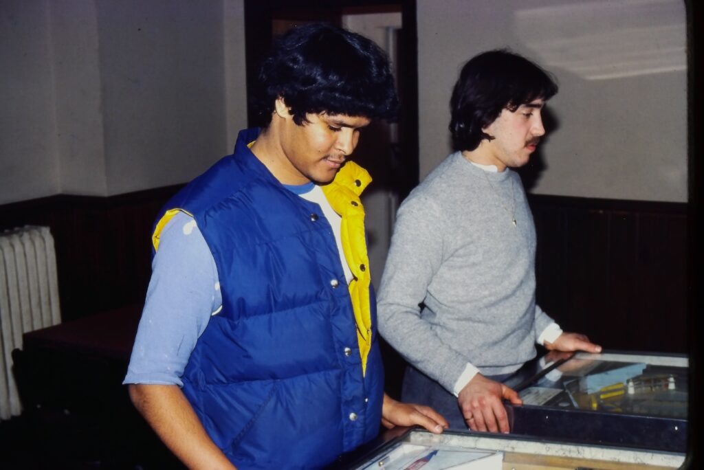 Mike Perkins and Jim Grande playing pinball.  Circa 1980.